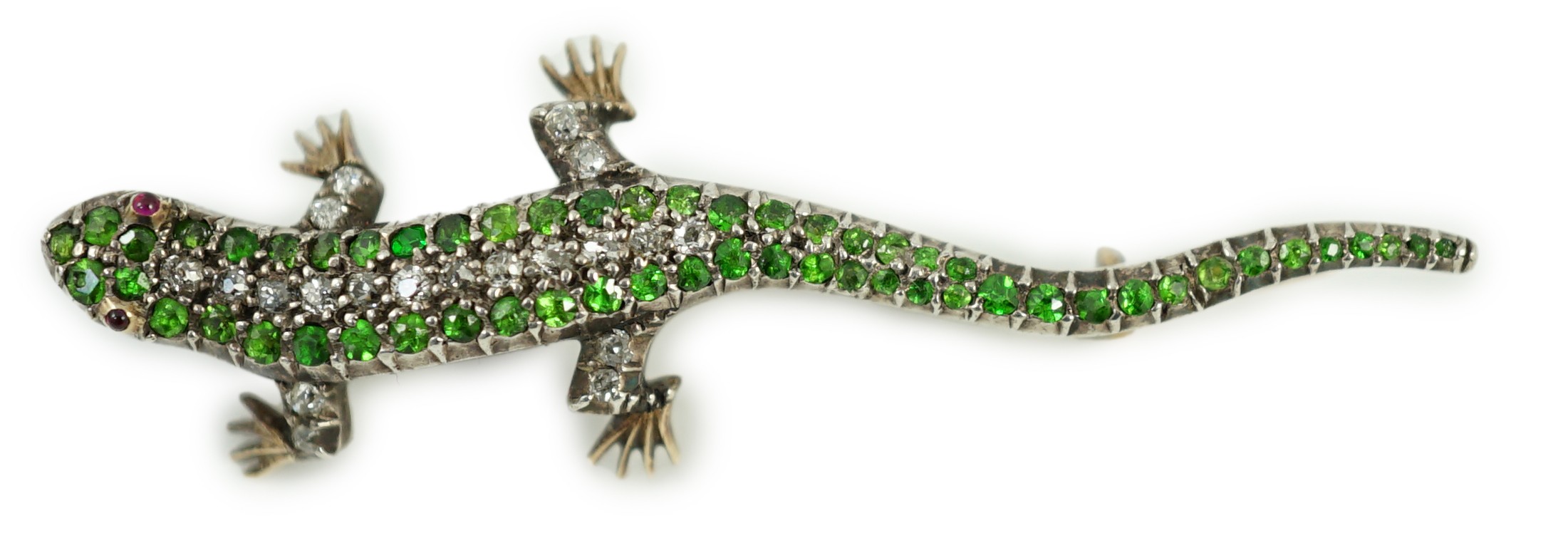 An Edwardian yellow metal, diamond and green garnet set lizard brooch, with red cabochon eyes, 50mm, gross weight 6.2 grams.